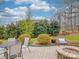 Paver patio features a stone fire pit and multiple seating areas at 4032 River Falls Dr, Lowell, NC 28098