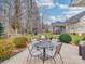Stone patio with outdoor seating and a view of the backyard at 4032 River Falls Dr, Lowell, NC 28098