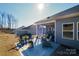 Spacious backyard featuring an extended patio, a cozy outdoor space with a firepit, and a view of the surrounding landscape at 4321 Duplin Dr, Charlotte, NC 28214
