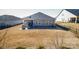 Backyard featuring a patio with seating, enclosed by a black metal fence at 4321 Duplin Dr, Charlotte, NC 28214