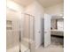 Bright bathroom features tiled shower with bench and glass doors adjacent to the main bedroom at 4321 Duplin Dr, Charlotte, NC 28214