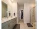 Bathroom with double vanity, quartz countertop, tile floors, and a glass-enclosed shower at 4321 Duplin Dr, Charlotte, NC 28214