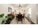Dining room featuring a modern chandelier, a dark wood table, and sliding glass doors at 4321 Duplin Dr, Charlotte, NC 28214