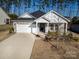 Charming single-Gathering home featuring stone accents, a two-car garage, and a welcoming front porch at 4321 Duplin Dr, Charlotte, NC 28214