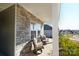 Relaxing front porch featuring comfortable seating, stone accents, and a view of the neighborhood at 4321 Duplin Dr, Charlotte, NC 28214
