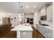 Contemporary kitchen featuring a large island, gray cabinetry, stainless steel appliances, and an open layout at 4321 Duplin Dr, Charlotte, NC 28214
