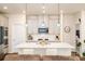 Bright kitchen with an island, modern pendant lighting, stainless steel appliances, and ample counter space at 4321 Duplin Dr, Charlotte, NC 28214
