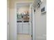 Functional laundry room with white appliances and storage shelves at 4321 Duplin Dr, Charlotte, NC 28214