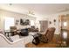 Open-concept living room featuring hardwood floors, comfortable seating, and plenty of natural light at 4321 Duplin Dr, Charlotte, NC 28214