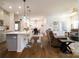 Open-concept living space with a kitchen island, modern lighting, and a comfortable seating area at 4321 Duplin Dr, Charlotte, NC 28214