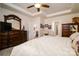 Bedroom featuring a trey ceiling, ceiling fan, large bed, and an ensuite bath at 4321 Duplin Dr, Charlotte, NC 28214