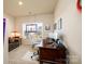 Cozy office space with plush carpet, bright window, desk and chair at 4321 Duplin Dr, Charlotte, NC 28214
