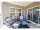 Cozy screened-in patio features blue outdoor seating and direct access to the home via sliding glass doors at 4321 Duplin Dr, Charlotte, NC 28214