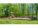 Community playground with various play structures, set amidst mature trees and adjacent to a lake at 4321 Duplin Dr, Charlotte, NC 28214
