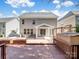 View of the home's backyard showcasing the deck, patio, and exterior architecture at 4329 Hunton Dale Nw Rd, Concord, NC 28027