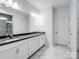 Bathroom features a double sink vanity with a large mirror and modern lighting at 4329 Hunton Dale Nw Rd, Concord, NC 28027