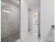 Modern bathroom with a glass-enclosed shower and tile flooring, door leading to bedroom at 4329 Hunton Dale Nw Rd, Concord, NC 28027