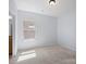 Bedroom featuring neutral carpet, light walls, and a large window at 4329 Hunton Dale Nw Rd, Concord, NC 28027