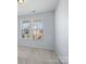 Bright bedroom featuring neutral carpet, light walls, and natural light through a large window at 4329 Hunton Dale Nw Rd, Concord, NC 28027