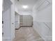 Walk-in closet with shelving units and ample storage space, carpet flooring at 4329 Hunton Dale Nw Rd, Concord, NC 28027