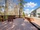 Large wooden deck surrounded by trees, features built in planters and space for outdoor gatherings at 4329 Hunton Dale Nw Rd, Concord, NC 28027