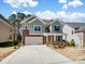 Charming two-story home with manicured lawn, stone accents, and attached two car garage at 4329 Hunton Dale Nw Rd, Concord, NC 28027