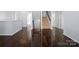 Open hallway with hardwood flooring and staircase leading to another floor at 4329 Hunton Dale Nw Rd, Concord, NC 28027
