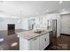 Modern kitchen island with stainless steel appliances, granite counters, and eat-in bar at 4329 Hunton Dale Nw Rd, Concord, NC 28027