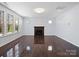 Spacious living room with fireplace, hardwood floors, and natural light at 4329 Hunton Dale Nw Rd, Concord, NC 28027