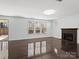 Living room with dark hardwood floors, fireplace, and natural light at 4329 Hunton Dale Nw Rd, Concord, NC 28027