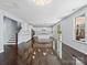 Bright open concept living space with stairs, kitchen, and access to the backyard at 4329 Hunton Dale Nw Rd, Concord, NC 28027