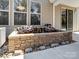 Water feature in backyard with a brick surround and sliding glass doors at 4329 Hunton Dale Nw Rd, Concord, NC 28027