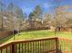 Large backyard with a well-maintained lawn, enclosed by a wooden fence, as viewed from a wooden deck at 4910 Summerside Dr, Clover, SC 29710