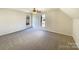 Spacious bedroom with neutral carpet and ample natural light from two windows at 4910 Summerside Dr, Clover, SC 29710