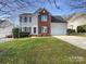 Beautiful two-story home with a well-manicured lawn, attached two-car garage, and mature trees at 4910 Summerside Dr, Clover, SC 29710