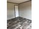 Bedroom featuring wood-look floors and a door at 514 Eagle Mills Rd # 3, Hamptonville, NC 27020