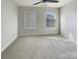 Bedroom with neutral carpet, ceiling fan, and two windows at 5629 Axil Ln, Charlotte, NC 28269