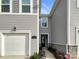 Charming townhouse showcasing a well-maintained front exterior and attached one car garage at 5629 Axil Ln, Charlotte, NC 28269