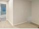 Neutral hallway featuring plush carpeting and light-filled view into the next room at 5629 Axil Ln, Charlotte, NC 28269
