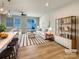 Bright living room with a white sofa, stylish rug, and sliding glass doors to the back yard at 5629 Axil Ln, Charlotte, NC 28269