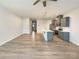 Open-concept living space with hardwood floors that connects to the kitchen with modern light fixtures at 5629 Axil Ln, Charlotte, NC 28269