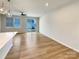 Spacious living room featuring light wood floors and sliding glass doors to the back yard at 5629 Axil Ln, Charlotte, NC 28269