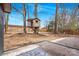 Backyard view featuring a spacious grassy yard and custom treehouse at 5825 Ruth Dr, Charlotte, NC 28215