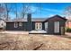 Dark brick home exterior featuring a concrete patio and double doors at 5825 Ruth Dr, Charlotte, NC 28215