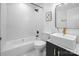 Bright bathroom with a white subway tile backsplash, black fixtures and a floating vanity with gold faucet at 5825 Ruth Dr, Charlotte, NC 28215