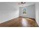 Bedroom featuring hardwood floors, a ceiling fan and a window with a view of the outside at 5825 Ruth Dr, Charlotte, NC 28215