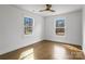 Bedroom with wood floors, white walls and two windows providing natural light at 5825 Ruth Dr, Charlotte, NC 28215