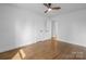 Bedroom featuring wood floors, white trim and walls, and access to ensuite bathroom at 5825 Ruth Dr, Charlotte, NC 28215