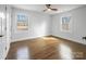Bedroom with wood floors, white walls and two windows providing ample natural light at 5825 Ruth Dr, Charlotte, NC 28215