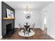 Stylish dining room with a brick fireplace, modern lighting, and hardwood floors at 5825 Ruth Dr, Charlotte, NC 28215